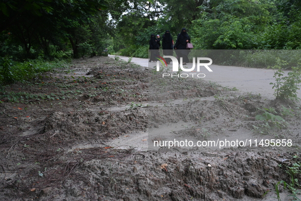 People are walking next to a graves line for unidentified bodies, those who were killed during the violence of the student movement at Rayer...