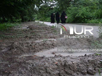 People are walking next to a graves line for unidentified bodies, those who were killed during the violence of the student movement at Rayer...