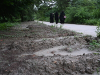 People are walking next to a graves line for unidentified bodies, those who were killed during the violence of the student movement at Rayer...