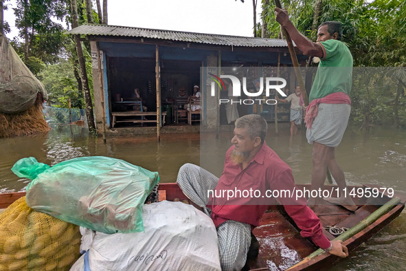 Bangladeshi people suffer from floods during heavy monsoon rains in rural Bangladesh on August 20, 2024. 