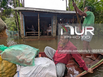 Bangladeshi people suffer from floods during heavy monsoon rains in rural Bangladesh on August 20, 2024. (