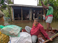 Bangladeshi people suffer from floods during heavy monsoon rains in rural Bangladesh on August 20, 2024. (