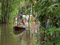 Bangladeshi people suffer from floods during heavy monsoon rains in rural Bangladesh on August 20, 2024. (