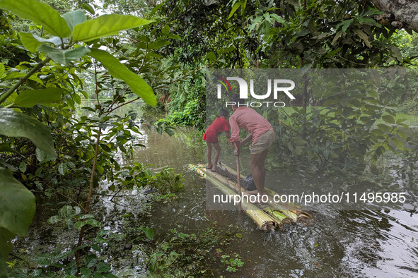 Bangladeshi people suffer from floods during heavy monsoon rains in rural Bangladesh on August 20, 2024. 