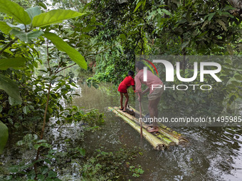 Bangladeshi people suffer from floods during heavy monsoon rains in rural Bangladesh on August 20, 2024. (