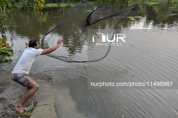 Bangladeshi people suffer from floods during heavy monsoon rains in rural Bangladesh on August 20, 2024. 