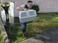 Passers-by are walking on flooded streets in the Colonia Culturas de Mexico in Chalco, State of Mexico, on August 20, 2024, where several fa...