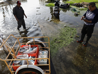 People are trying to walk on flooded streets in Chalco, State of Mexico, on August 20, 2024, where several families are being severely affec...