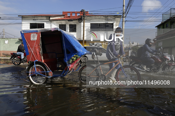 Transporters are circulating on flooded streets in the Colonia Culturas de Mexico in Chalco, State of Mexico, on August 20, 2024, where seve...