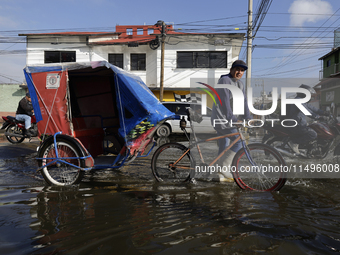 Transporters are circulating on flooded streets in the Colonia Culturas de Mexico in Chalco, State of Mexico, on August 20, 2024, where seve...