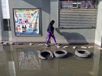 People are trying to walk on flooded streets in Chalco, State of Mexico, on August 20, 2024, where several families are being severely affec...