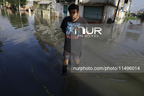 People are trying to walk on flooded streets in Chalco, State of Mexico, on August 20, 2024, where several families are being severely affec...