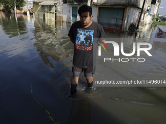 People are trying to walk on flooded streets in Chalco, State of Mexico, on August 20, 2024, where several families are being severely affec...