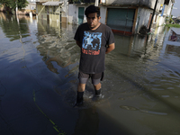 People are trying to walk on flooded streets in Chalco, State of Mexico, on August 20, 2024, where several families are being severely affec...