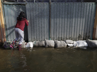 People are trying to walk on flooded streets in Chalco, State of Mexico, on August 20, 2024, where several families are being severely affec...