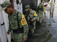 Members of the Mexican army are trying to walk on flooded streets in Chalco, State of Mexico, on August 20, 2024, where several families are...