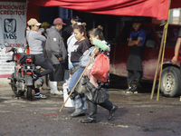 Passers-by are walking on flooded streets in the Colonia Culturas de Mexico in Chalco, State of Mexico, on August 20, 2024, where several fa...