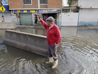 People are trying to walk on flooded streets in Chalco, State of Mexico, on August 20, 2024, where several families are being severely affec...