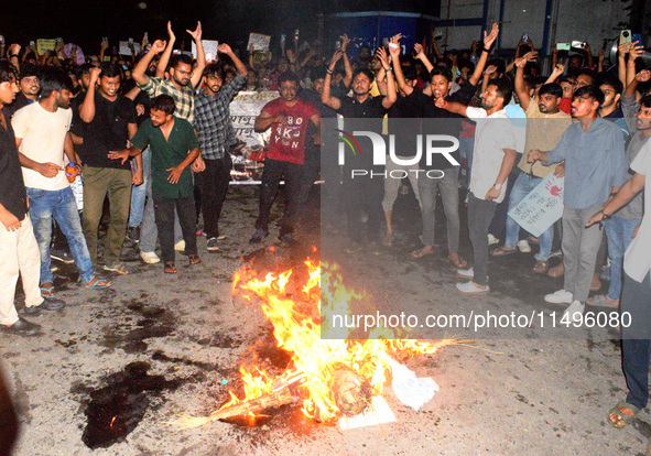 Trainee doctors, doctors, youths, and women are shouting slogans prior to burning an effigy of the Kolkata RG Kar Principal as part of a pro...