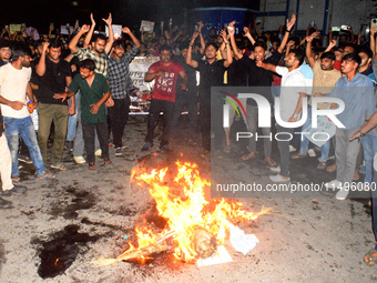 Trainee doctors, doctors, youths, and women are shouting slogans prior to burning an effigy of the Kolkata RG Kar Principal as part of a pro...