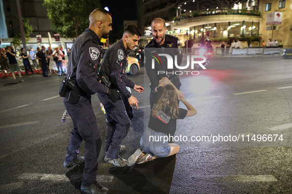 Israeli police officers are moving demonstrators blocking a street during a protest in Jerusalem, Israel, on August 20, 2024. People are gat...