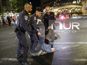 Israeli police officers are moving demonstrators blocking a street during a protest in Jerusalem, Israel, on August 20, 2024. People are gat...