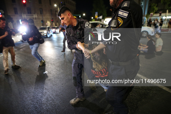 Israeli police officers are moving demonstrators blocking a street during a protest in Jerusalem, Israel, on August 20, 2024. People are gat...