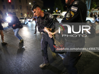 Israeli police officers are moving demonstrators blocking a street during a protest in Jerusalem, Israel, on August 20, 2024. People are gat...