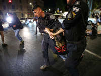 Israeli police officers are moving demonstrators blocking a street during a protest in Jerusalem, Israel, on August 20, 2024. People are gat...