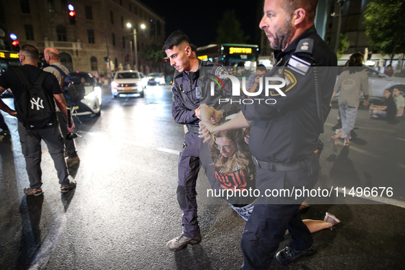 Israeli police officers are moving demonstrators blocking a street during a protest in Jerusalem, Israel, on August 20, 2024. People are gat...