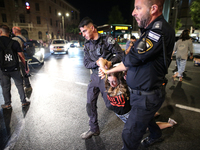 Israeli police officers are moving demonstrators blocking a street during a protest in Jerusalem, Israel, on August 20, 2024. People are gat...