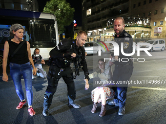 Israeli police officers are moving demonstrators blocking a street during a protest in Jerusalem, Israel, on August 20, 2024. People are gat...