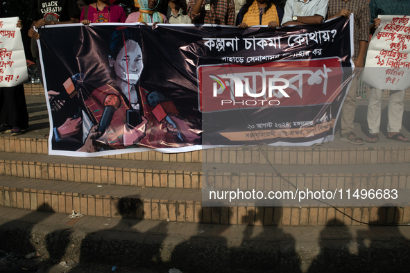 Tribal students of Dhaka University are holding a rally with a banner displaying a portrait of Kalpana Chakma in Dhaka, Bangladesh, on Augus...