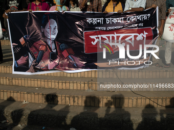 Tribal students of Dhaka University are holding a rally with a banner displaying a portrait of Kalpana Chakma in Dhaka, Bangladesh, on Augus...