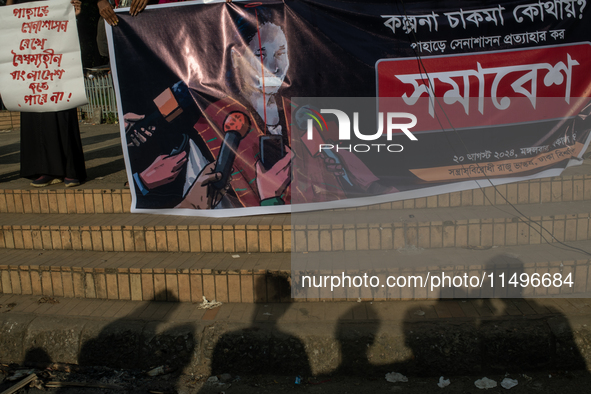 Tribal students of Dhaka University are holding a rally with a banner displaying a portrait of Kalpana Chakma in Dhaka, Bangladesh, on Augus...