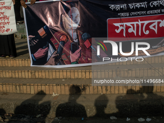 Tribal students of Dhaka University are holding a rally with a banner displaying a portrait of Kalpana Chakma in Dhaka, Bangladesh, on Augus...