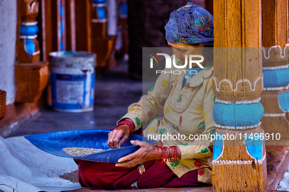 A woman is winnowing grain in the Sainji Village (Corn Village) in Mussoorie, Uttarakhand, India, on April 18, 2024. This village is famous...