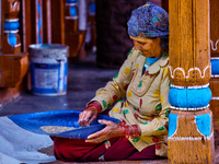 A woman is winnowing grain in the Sainji Village (Corn Village) in Mussoorie, Uttarakhand, India, on April 18, 2024. This village is famous...