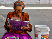 A woman is winnowing grain in the Sainji Village (Corn Village) in Mussoorie, Uttarakhand, India, on April 18, 2024. This village is famous...