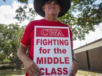 Unionized workers are picketing near the entrance of an AT&T facility in Daytona Beach, Florida, on August 20, 2024, as part of the Communic...