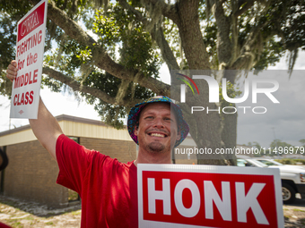 Unionized workers are picketing near the entrance of an AT&T facility in Daytona Beach, Florida, on August 20, 2024, as part of the Communic...