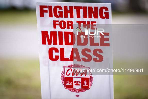 Unionized workers are picketing near the entrance of an AT&T facility in Daytona Beach, Florida, on August 20, 2024, as part of the Communic...