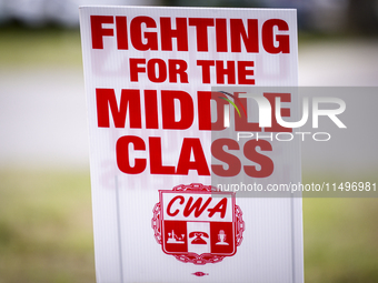 Unionized workers are picketing near the entrance of an AT&T facility in Daytona Beach, Florida, on August 20, 2024, as part of the Communic...