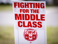 Unionized workers are picketing near the entrance of an AT&T facility in Daytona Beach, Florida, on August 20, 2024, as part of the Communic...