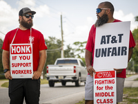 Unionized workers are picketing near the entrance of an AT&T facility in Daytona Beach, Florida, on August 20, 2024, as part of the Communic...