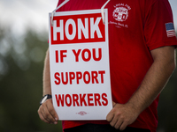 Unionized workers are picketing near the entrance of an AT&T facility in Daytona Beach, Florida, on August 20, 2024, as part of the Communic...