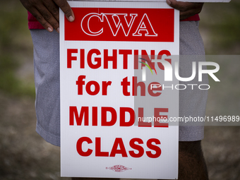 Unionized workers are picketing near the entrance of an AT&T facility in Daytona Beach, Florida, on August 20, 2024, as part of the Communic...