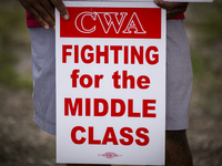 Unionized workers are picketing near the entrance of an AT&T facility in Daytona Beach, Florida, on August 20, 2024, as part of the Communic...