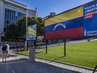 A person is walking near a billboard with the inscription in Spanish ''Venezuela Libre'' (free Venezuela) in the center of Lisbon, Portugal,...