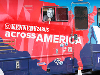 A person holds a sign depicting Robert F. Kennedy Jr. out of a window from a campaign bus near the Democratic National Convention in Chicago...